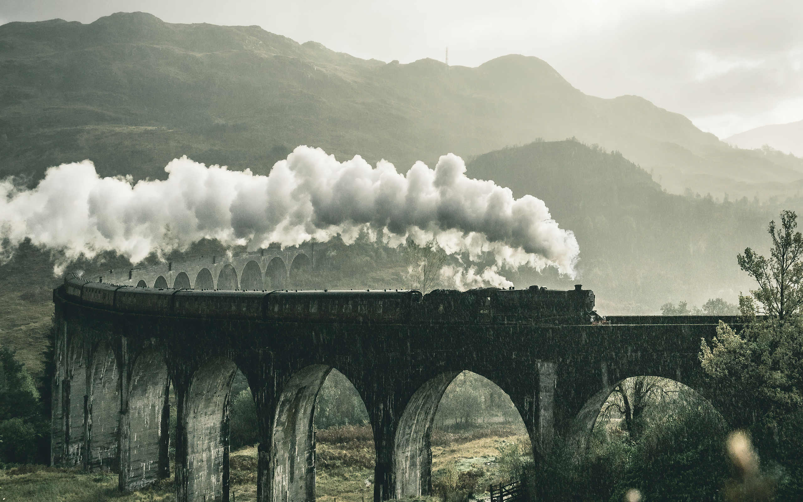black-train-on-railway-bridge-under-heavy-clouds-8o-2560x1600.jpg